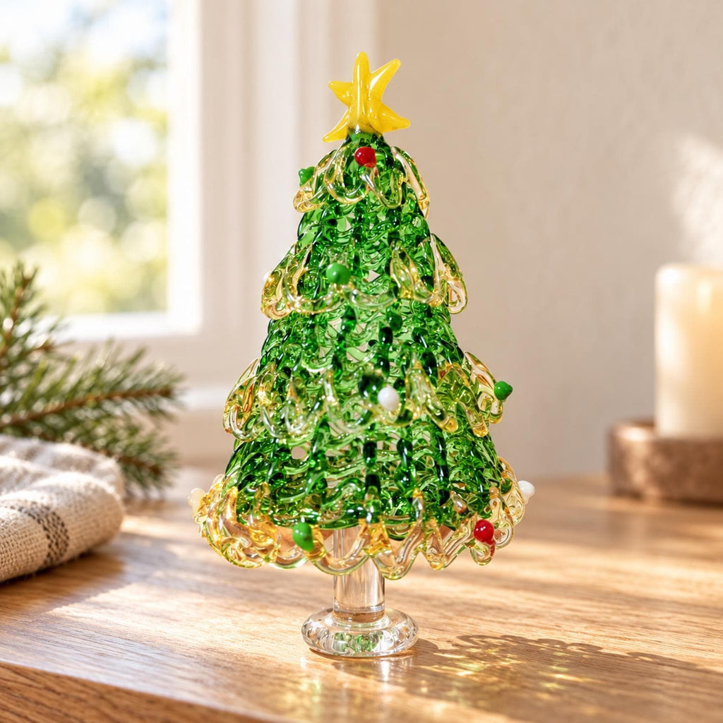 May include: A decorative glass Christmas tree figurine featuring a translucent green and yellow swirled design. The tree is topped with a bright yellow star and accented with small red, green, and white glass spheres throughout the branches.