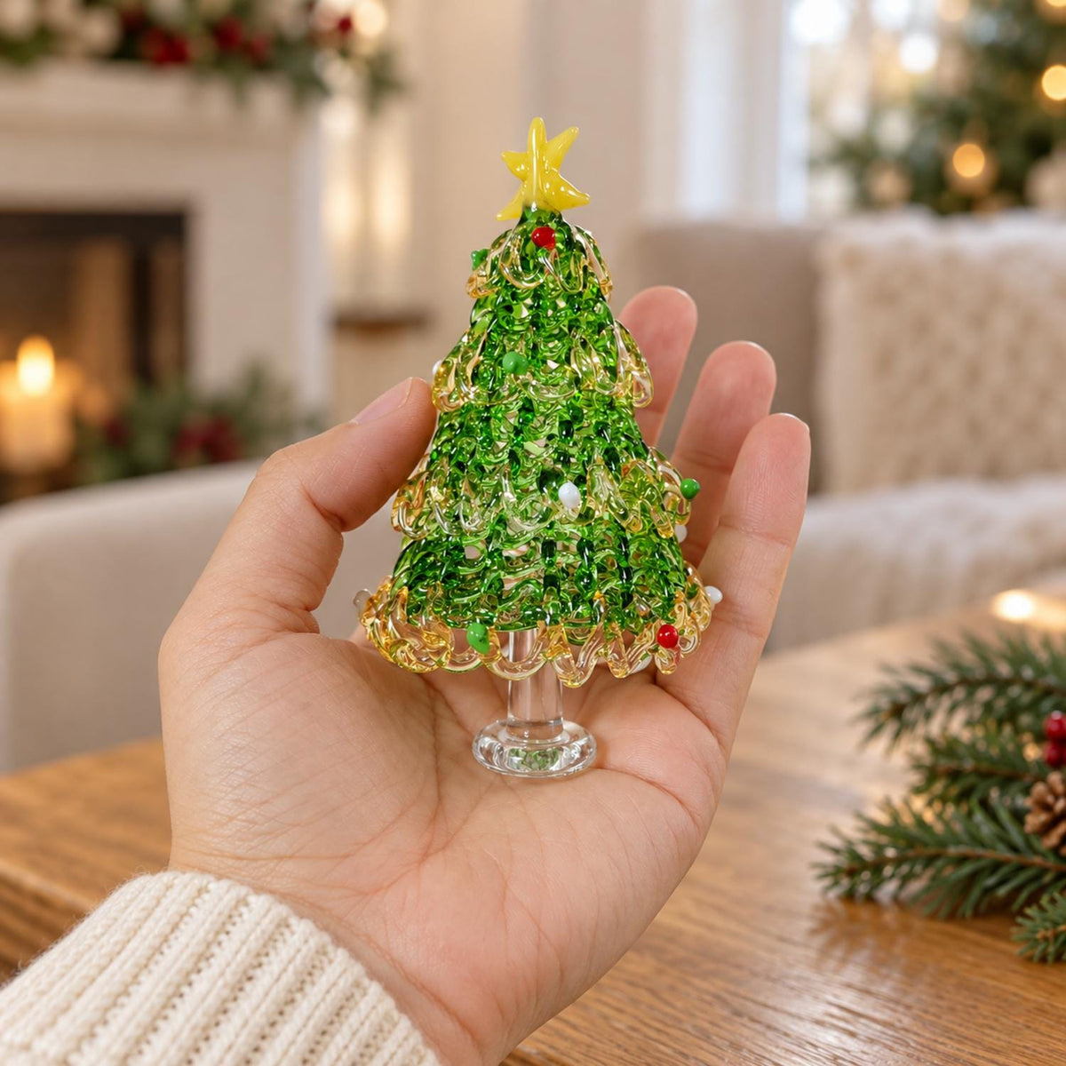 May include: A small, handcrafted glass Christmas tree figurine featuring a vibrant green, textured body with swirling clear glass accents. The tree is topped with a bright yellow glass star and decorated with tiny red and white glass beads.