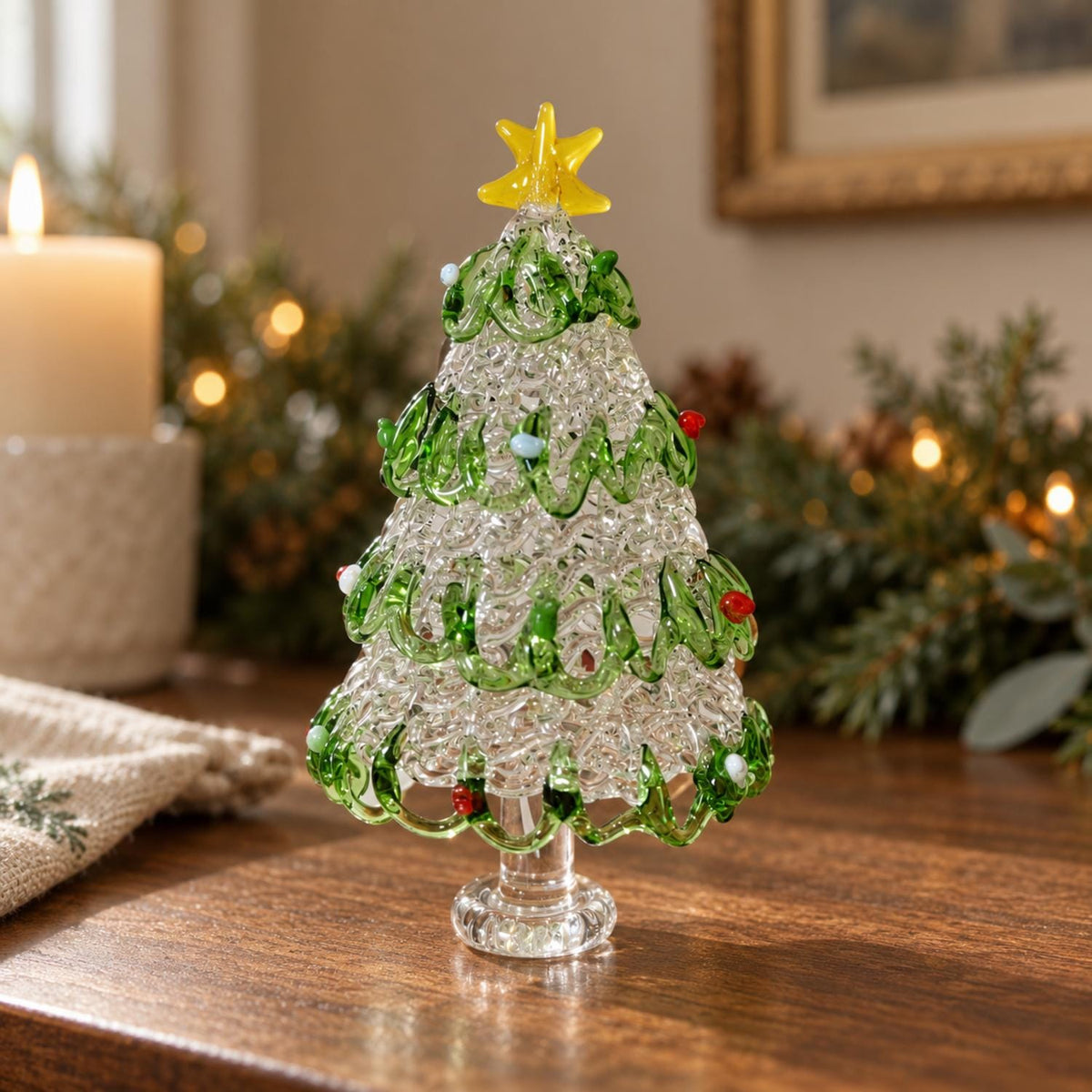 May include: A clear glass Christmas tree figurine with a textured, bubbled surface. It features swirling green glass branches wrapped around the body, accented with small red and white glass beads. A bright yellow glass star sits on top.