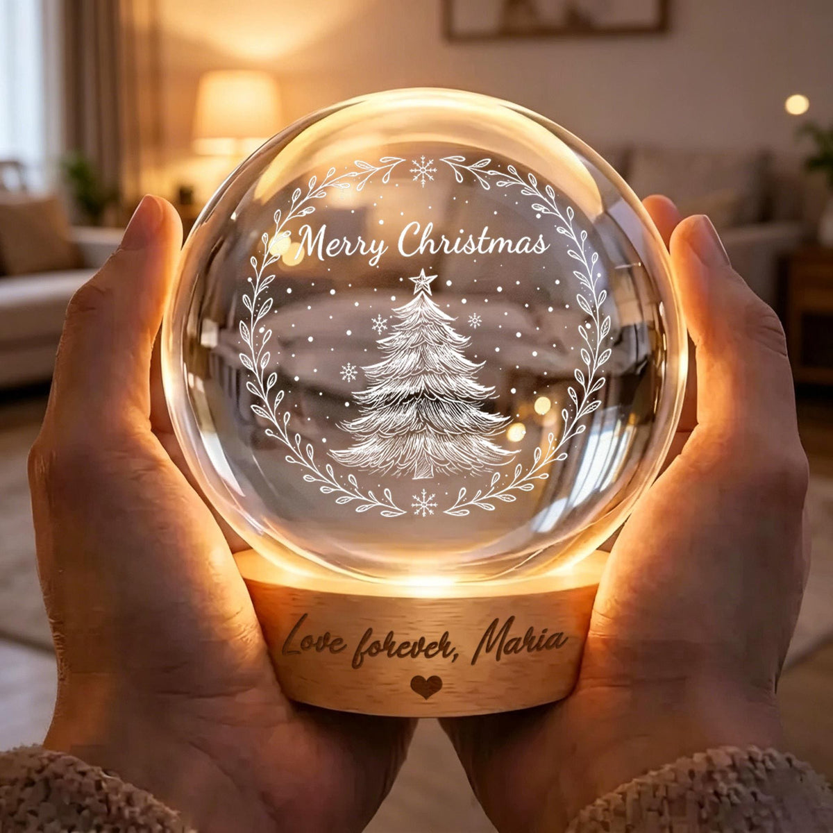 May include: A spherical glass night light featuring an etched Christmas tree and the text Merry Christmas inside a wreath. The light sits on a circular wooden base engraved with the text Love forever, Maria and a small heart symbol.