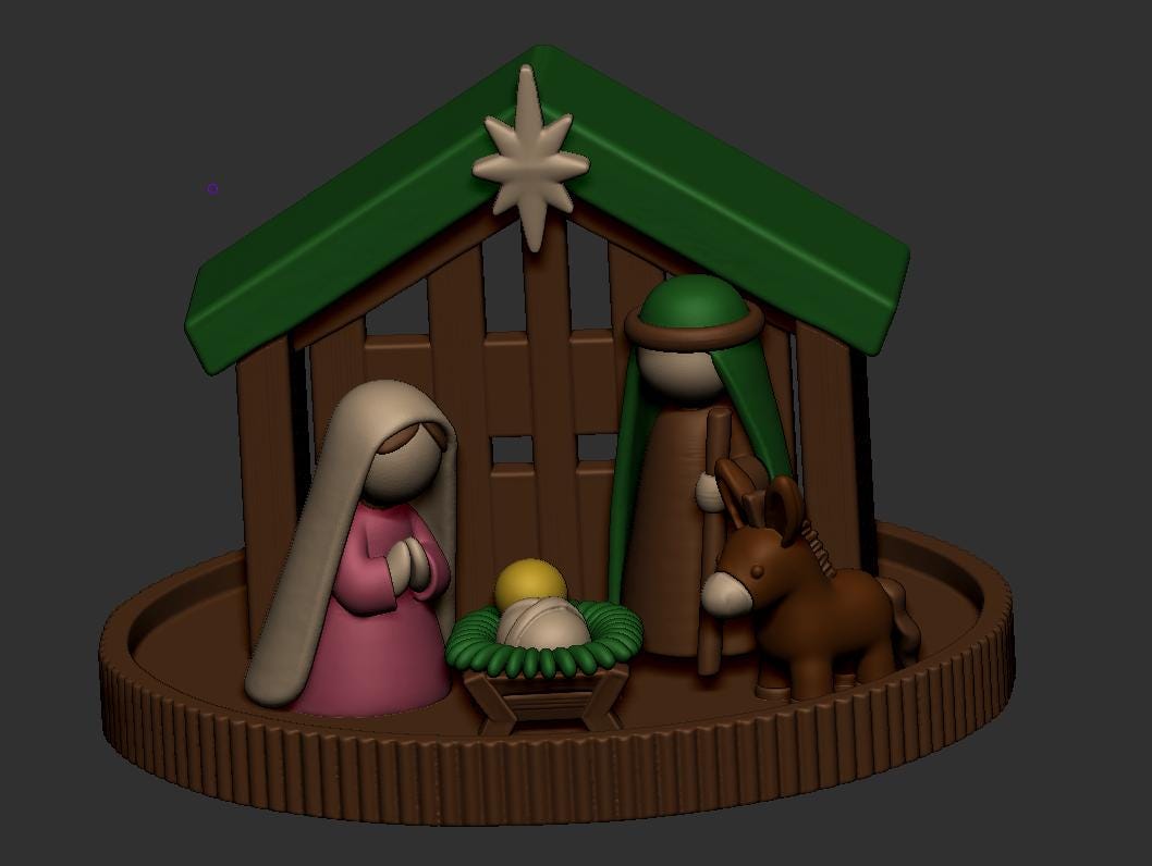 May include: A 3D-printed nativity scene featuring a brown stable with a green roof and a star at the peak. Inside, stylized figures include a pink-robed figure, a brown-robed figure with a green head covering, a small donkey, and a yellow-topped infant in a green manger.
