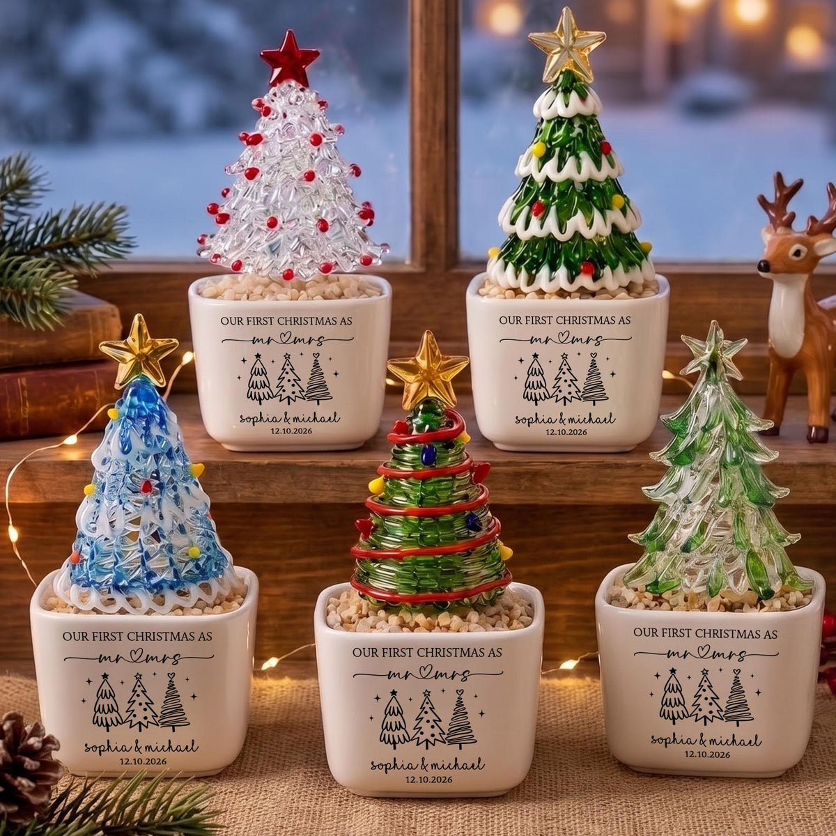 May include: Five white ceramic square planters, each containing a glass Christmas tree ornament topped with a gold or red star. The planters feature the text "OUR FIRST CHRISTMAS AS mr & mrs", "Sophia & Michael", and "12.10.2026" with tree icons.