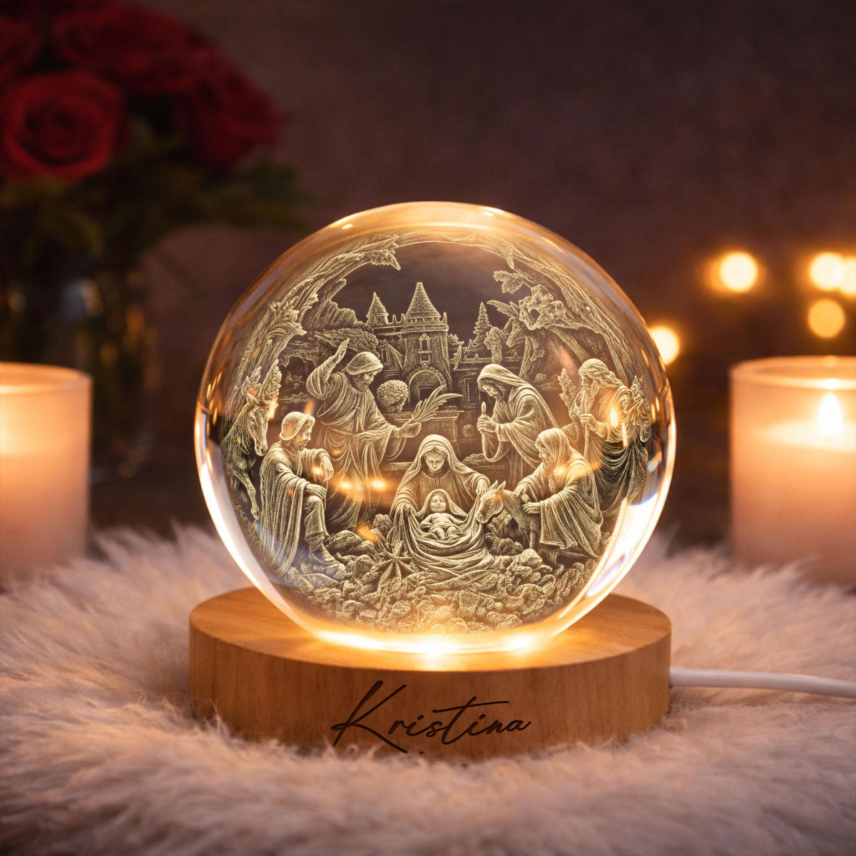 May include: A clear glass sphere featuring an intricate 3D laser-engraved nativity scene with figures of the holy family and animals. The sphere rests on a circular light-colored wooden base with the name Kristina engraved in black script.