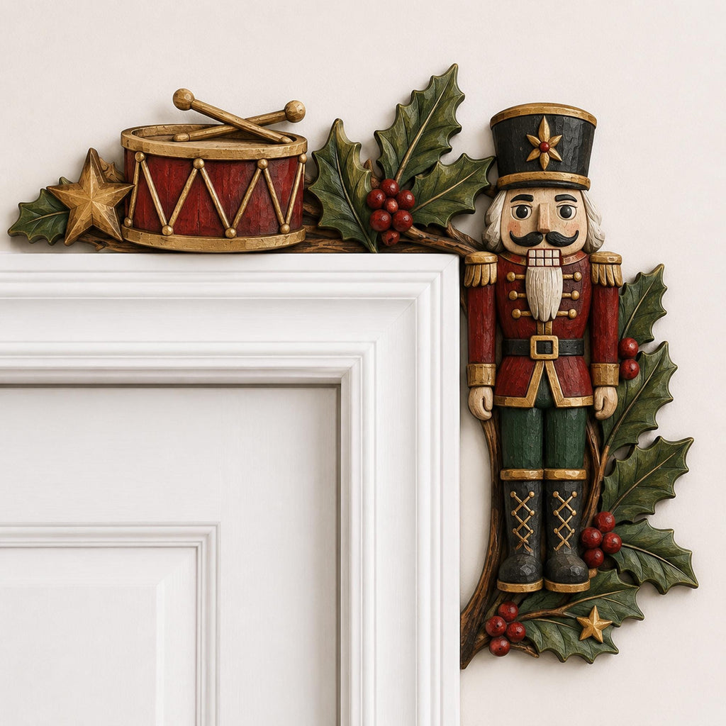 May include: A decorative door corner topper featuring a nutcracker soldier in a red and green uniform, a red drum with gold accents, and crossed drumsticks. The design is accented with green holly leaves, red berries, and small gold stars.