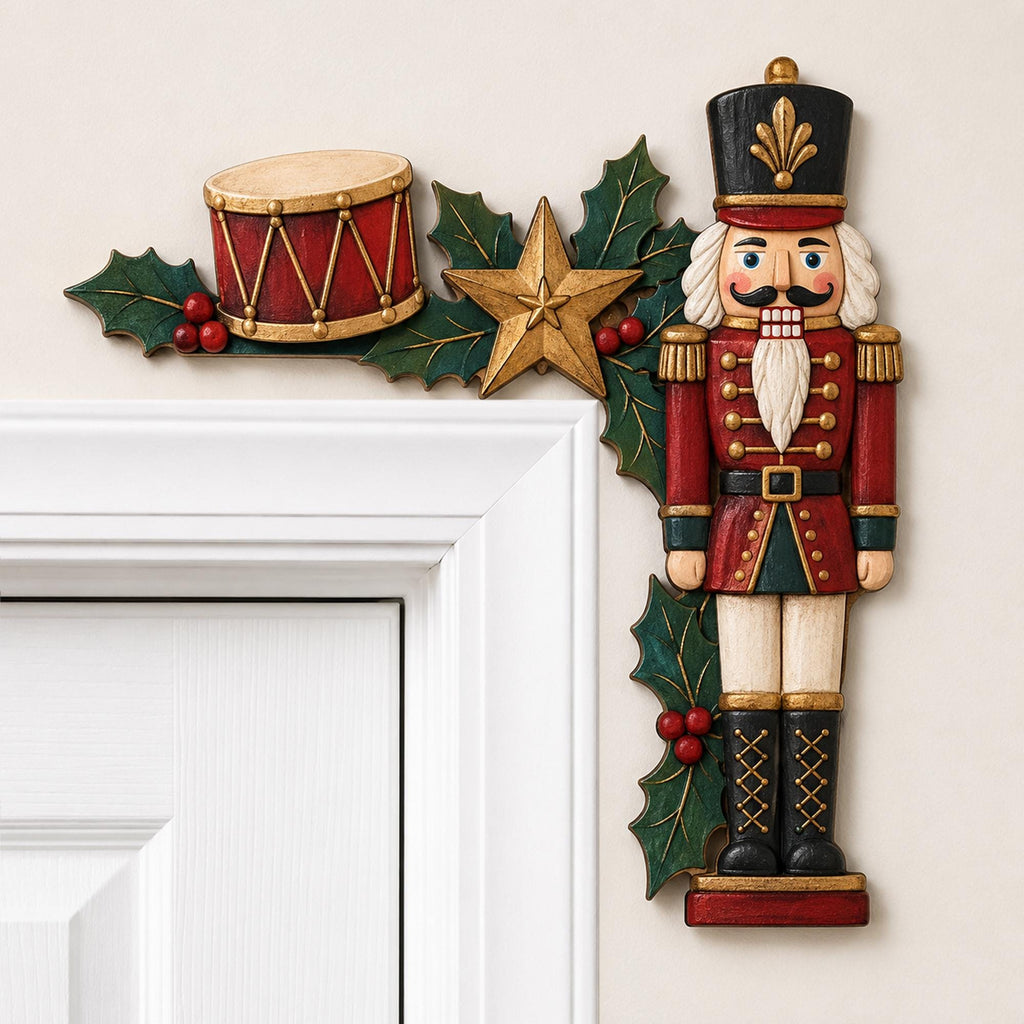 May include: A decorative door corner accent featuring a nutcracker figure in a red and black uniform, a red drum, a gold star, and green holly leaves with red berries. The piece is designed to frame the upper right corner of a door frame.