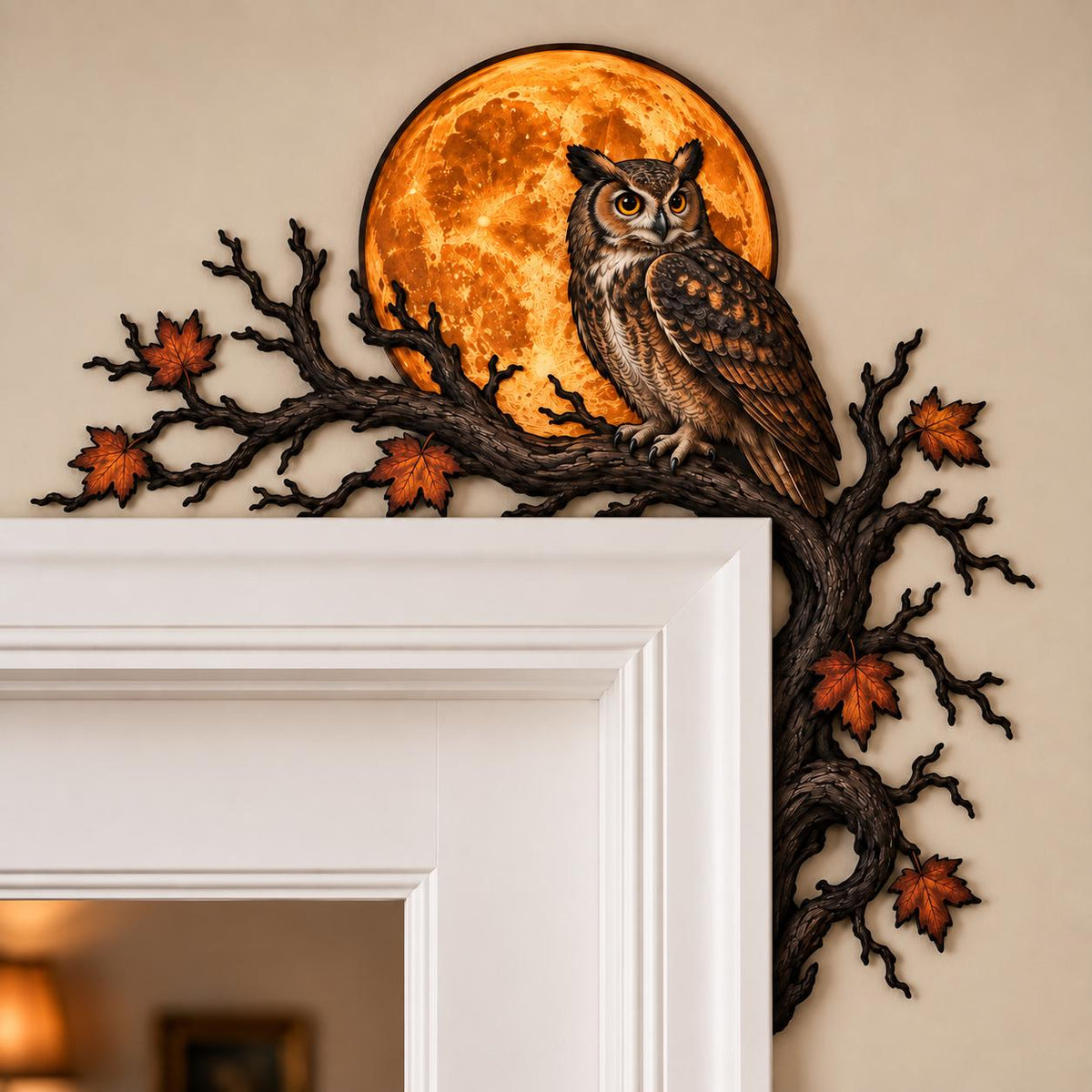 May include: A decorative wall accent featuring a brown owl perched on a dark, textured tree branch. The branch extends horizontally and vertically, adorned with orange and brown autumn leaves. A large, glowing orange full moon sits behind the owl.
