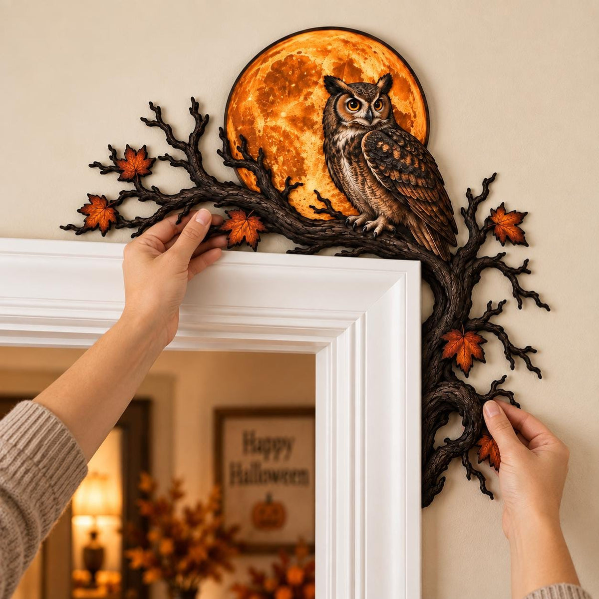 May include: A decorative door corner accent featuring a brown owl perched on a dark, gnarled tree branch. The branch is adorned with orange and red autumn leaves and is set against a large, circular, glowing orange full moon background.