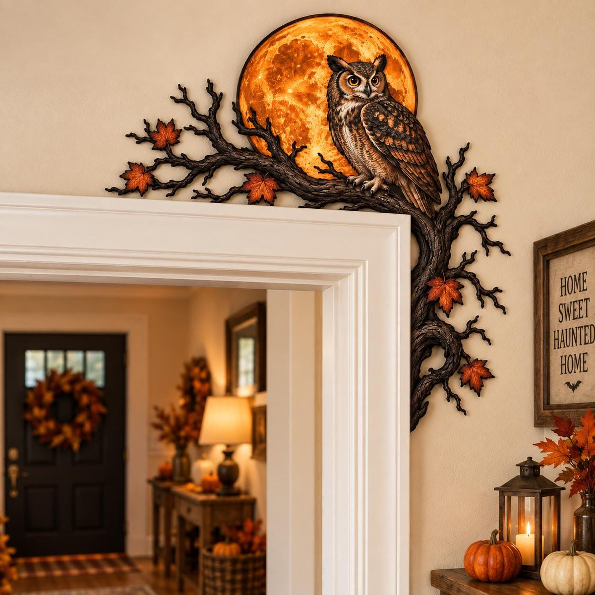 May include: A decorative wall accent designed for a door corner, featuring a brown owl perched on a dark, gnarled tree branch. The branch is adorned with orange and red autumn leaves and frames a large, glowing, circular orange full moon.