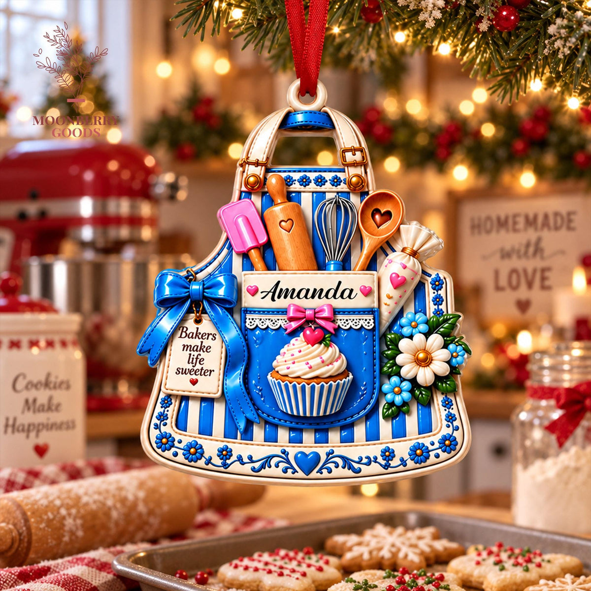 May include: A decorative apron-shaped ornament featuring blue and white vertical stripes, a central pocket with a cupcake graphic, a pink bow, and kitchen tools including a rolling pin, whisk, and spatula. The text reads Amanda and Bakers make life sweeter.