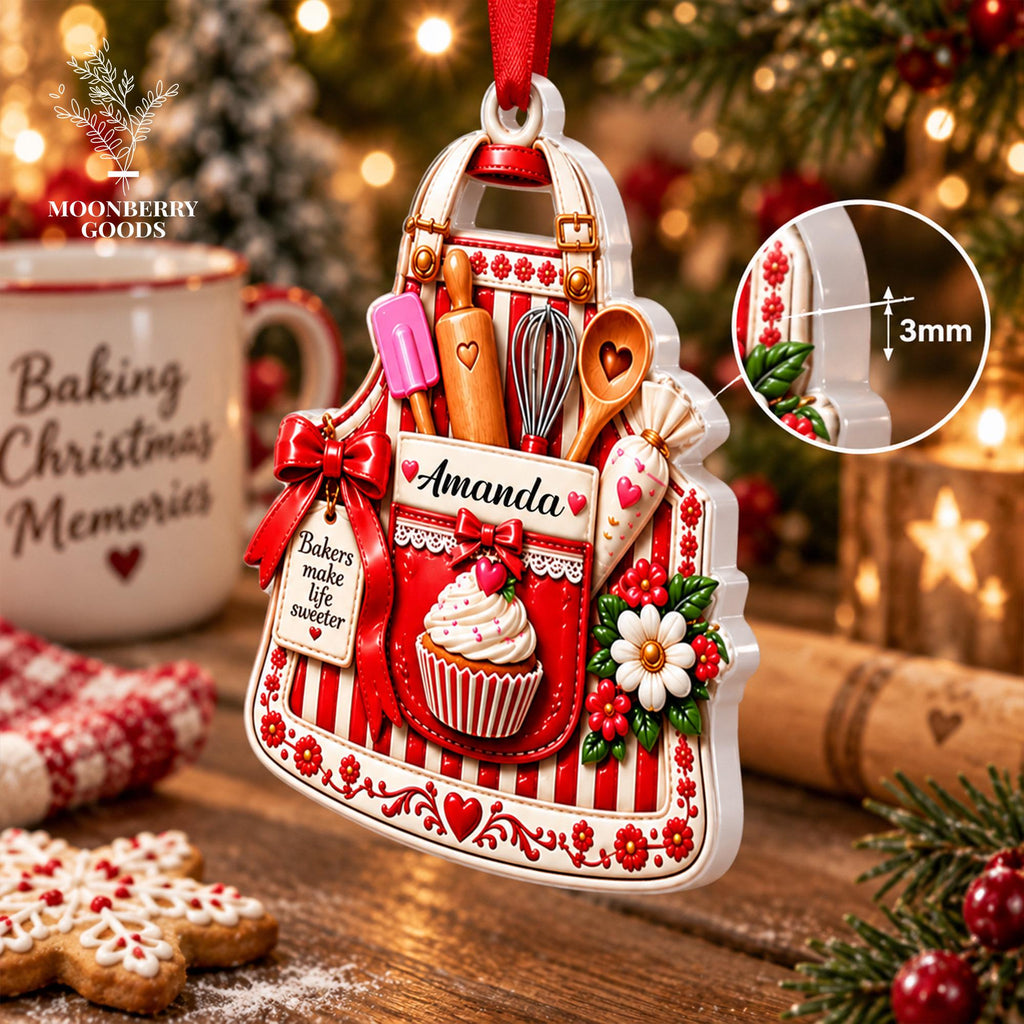 May include: A white and red striped apron-shaped Christmas ornament featuring a pocket with the name Amanda, a cupcake, a pink spatula, a wooden rolling pin, a whisk, a wooden spoon, and a piping bag. A tag reads Bakers make life sweeter. 3mm thick.