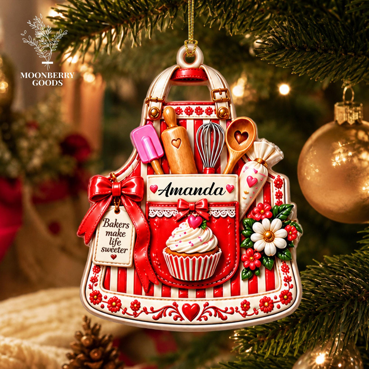 May include: A red and white striped apron-shaped Christmas ornament featuring a cupcake, a rolling pin, a whisk, a spatula, and a piping bag. The ornament displays the name Amanda and a tag with the text Bakers make life sweeter.