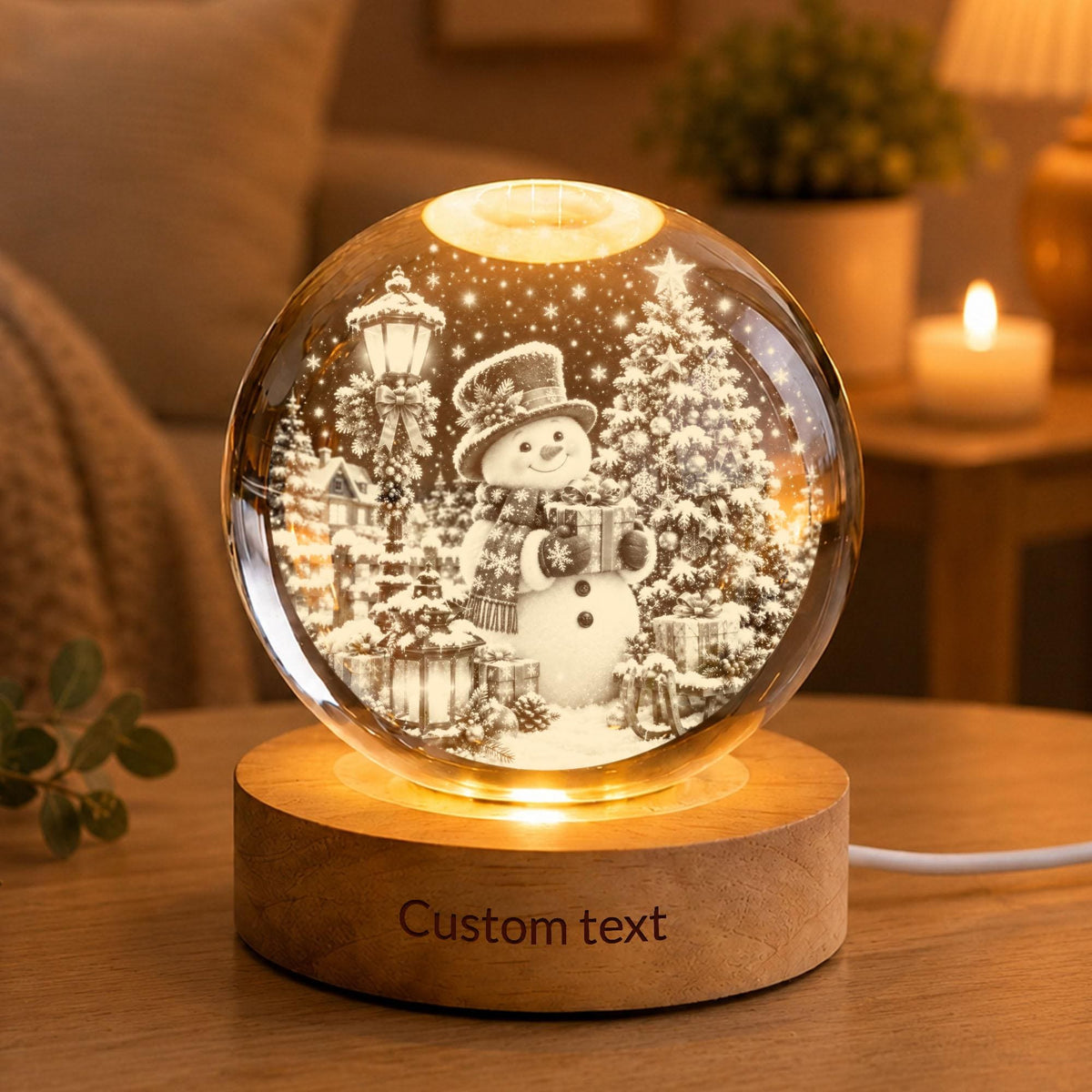 May include: A spherical glass night light featuring an internal 3D laser-etched scene of a snowman wearing a hat and scarf, standing next to a Christmas tree and a street lamp. The glass sphere rests on a circular wooden base with Custom text.