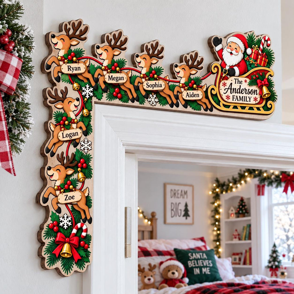 May include: A wooden Christmas door corner sign featuring Santa Claus in a sleigh and six reindeer. Each reindeer has a name tag: Ryan, Megan, Sophia, Aiden, Logan, and Zoe. The sleigh is labeled The Anderson Family. Decorated with pine and bells.