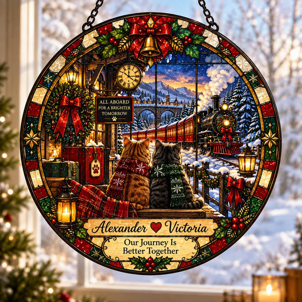 May include: A circular stained glass ornament featuring two cats wearing scarves, sitting before a steam train in a snowy landscape. The design includes a red bow, a clock, a sign reading All Aboard For A Brighter Tomorrow, and the text Alexander Victoria Our Journey Is Better Together.