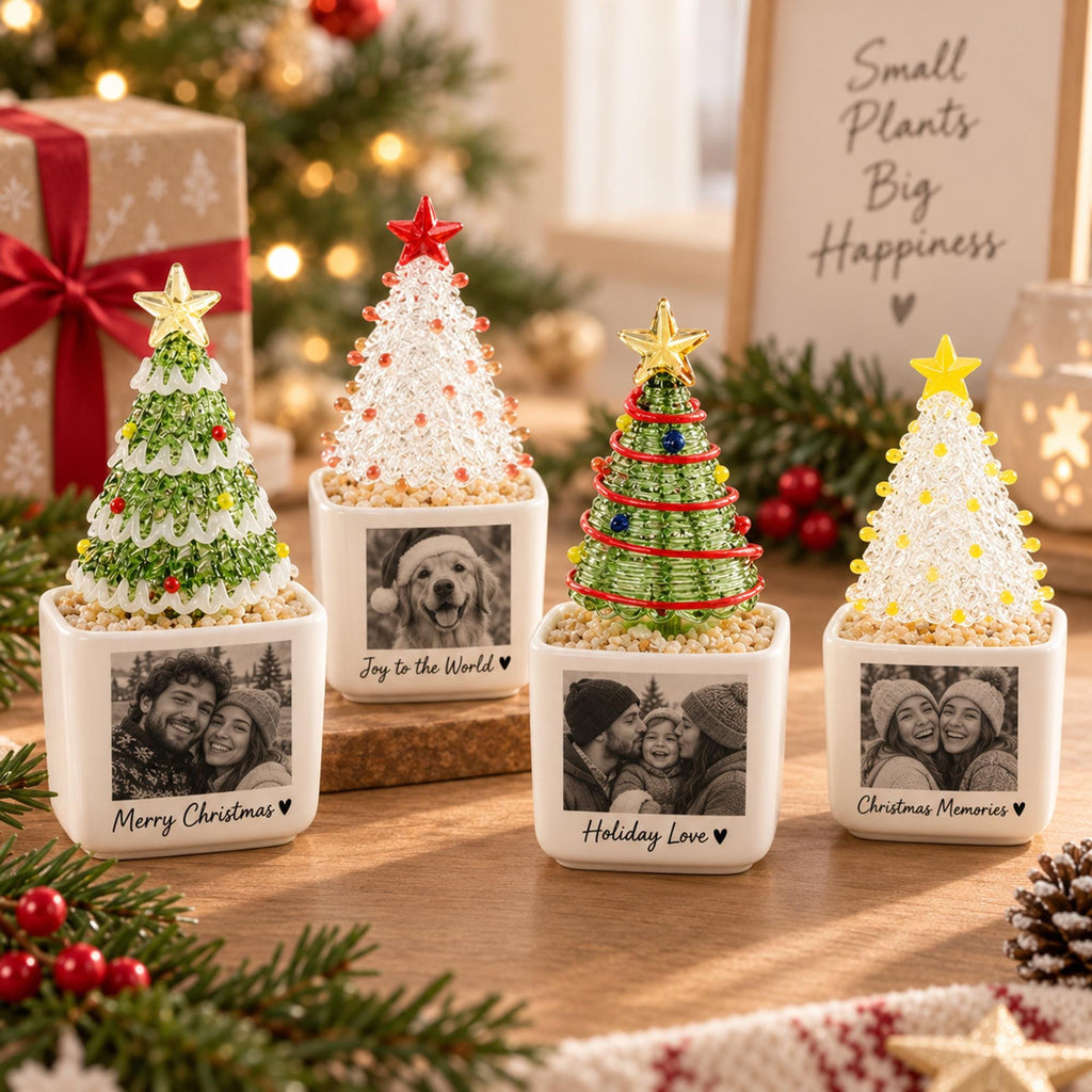 May include: Four square white ceramic planters, each featuring a custom black and white photograph and text, topped with a decorative beaded Christmas tree. The trees have star toppers and are set in a base of small, light-colored pebbles.