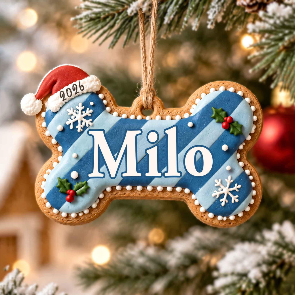 May include: A bone-shaped Christmas ornament with a light and dark blue striped pattern. The center features the name Milo in white text. It includes a red Santa hat with the year 2026, white snowflakes, and holly berry accents with a twine loop.