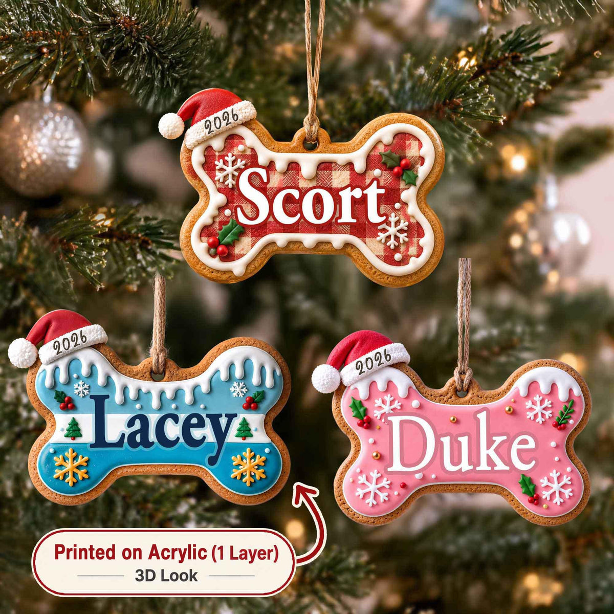 May include: Three bone-shaped Christmas ornaments with white icing edges, each featuring a red Santa hat with the year 2026. The top ornament has a red plaid pattern with the name Scort. The bottom left is blue with the name Lacey, and the bottom right is pink with the name Duke. All include snowflake and holly accents.