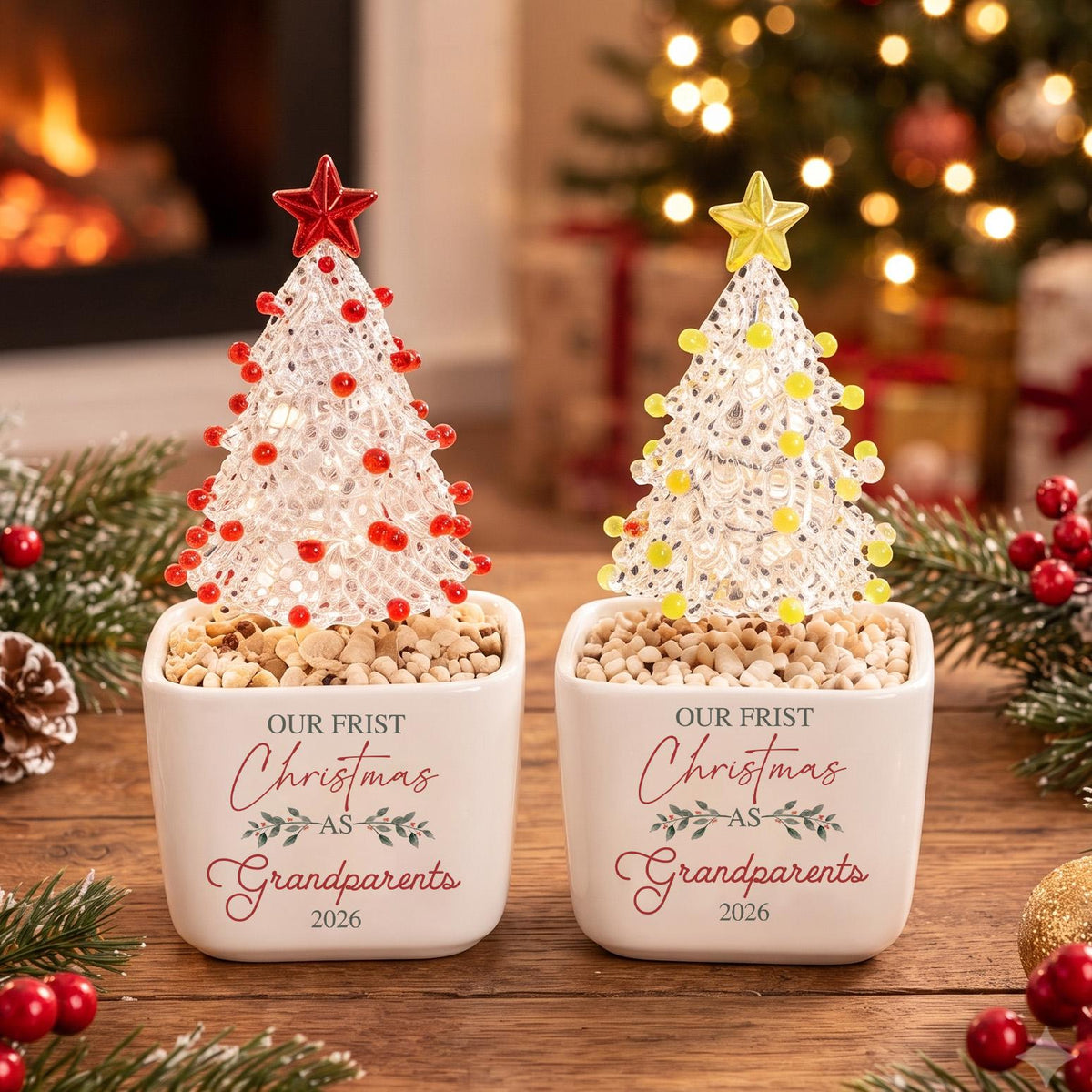 May include: Two white ceramic square planters containing clear textured Christmas tree ornaments with red and yellow beads, topped with stars. The planters feature the text "OUR FRIST Christmas AS Grandparents 2026" in red and gray script.