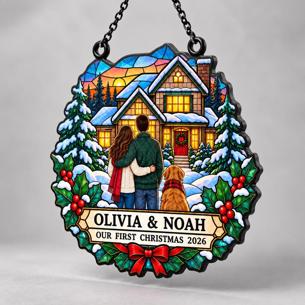 May include: A circular stained-glass style ornament featuring a couple and a golden dog standing before a snow-covered house. The text reads OLIVIA & NOAH OUR FIRST CHRISTMAS 2026. The design includes pine trees, holly leaves, and a red bow.