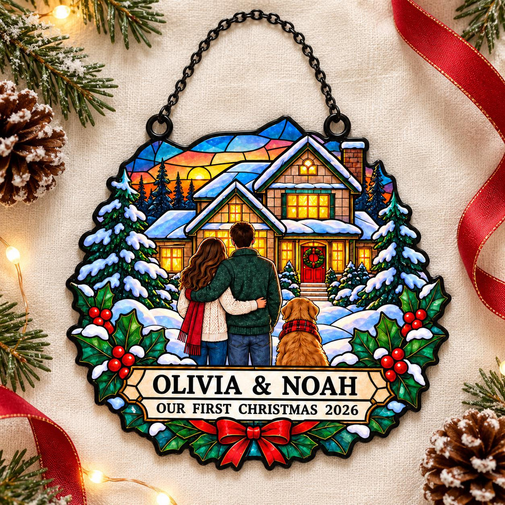May include: A stained glass style hanging ornament featuring a couple and a golden retriever standing before a snow-covered house. The text reads OLIVIA & NOAH OUR FIRST CHRISTMAS 2026. The design includes pine trees, holly, and a red bow.