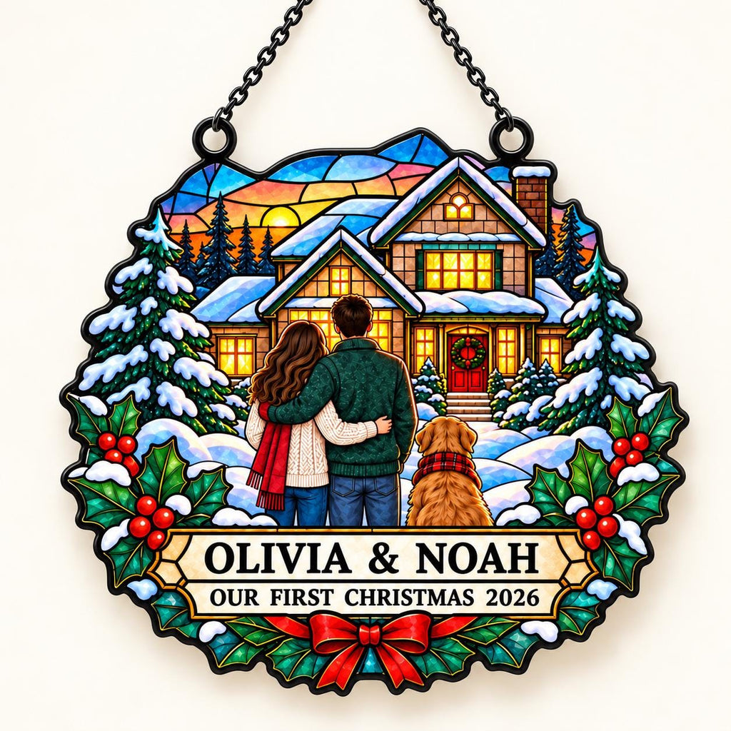 May include: A circular stained-glass style hanging ornament featuring a couple and a dog standing before a snow-covered house. The text reads OLIVIA & NOAH OUR FIRST CHRISTMAS 2026. The design includes pine trees, holly leaves, and a red bow.