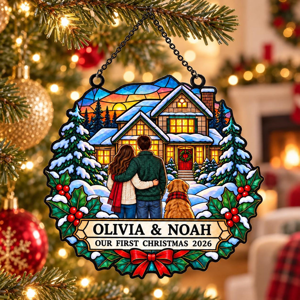 May include: A circular stained-glass style ornament featuring a couple and a dog standing before a house in the snow. The text reads OLIVIA & NOAH and OUR FIRST CHRISTMAS 2026. The design includes holly leaves, red berries, and a red bow.
