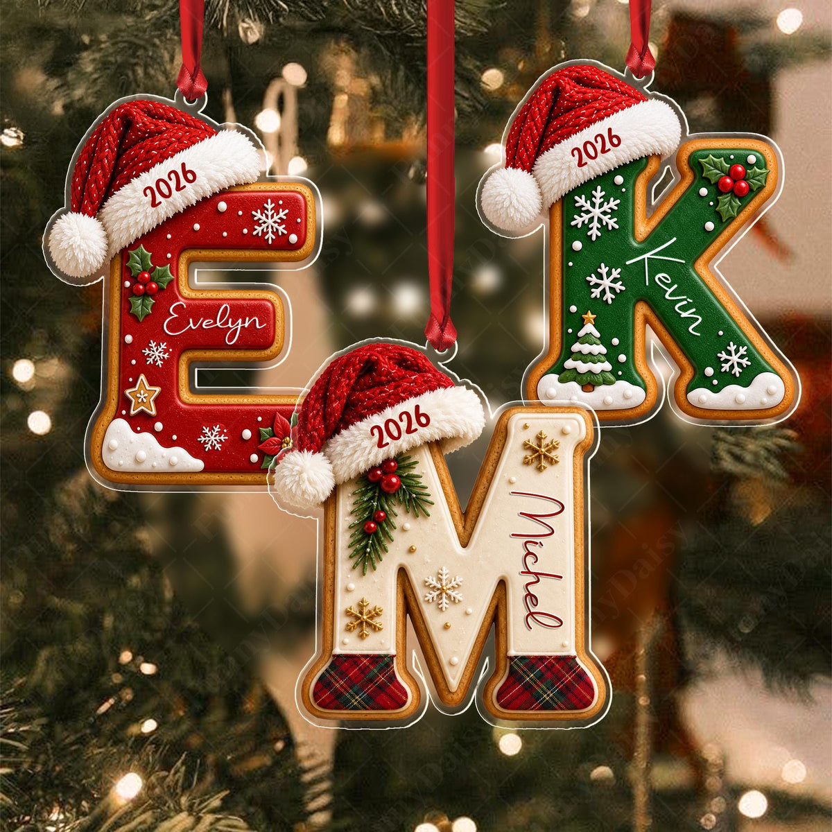 May include: Three letter-shaped Christmas ornaments featuring red, green, and white gingerbread-style designs. Each letter is topped with a red Santa hat displaying the year 2026 and personalized with the names Evelyn, Kevin, and Michel.