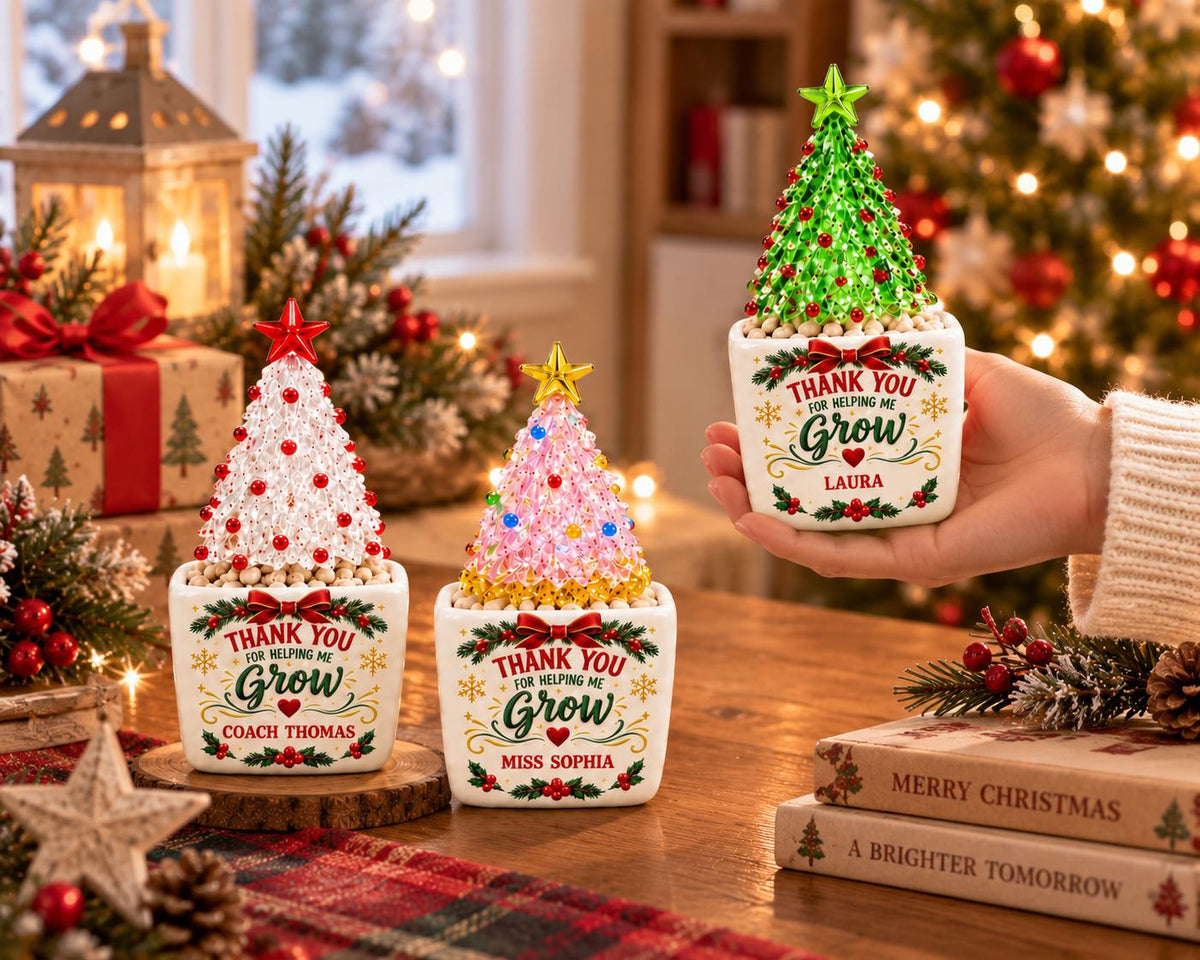May include: Three ceramic planters with artificial Christmas trees. Each white square pot features the text "THANK YOU FOR HELPING ME GROW" with a red bow, holly, and a personalized name. The trees are decorated with colorful beads and stars.