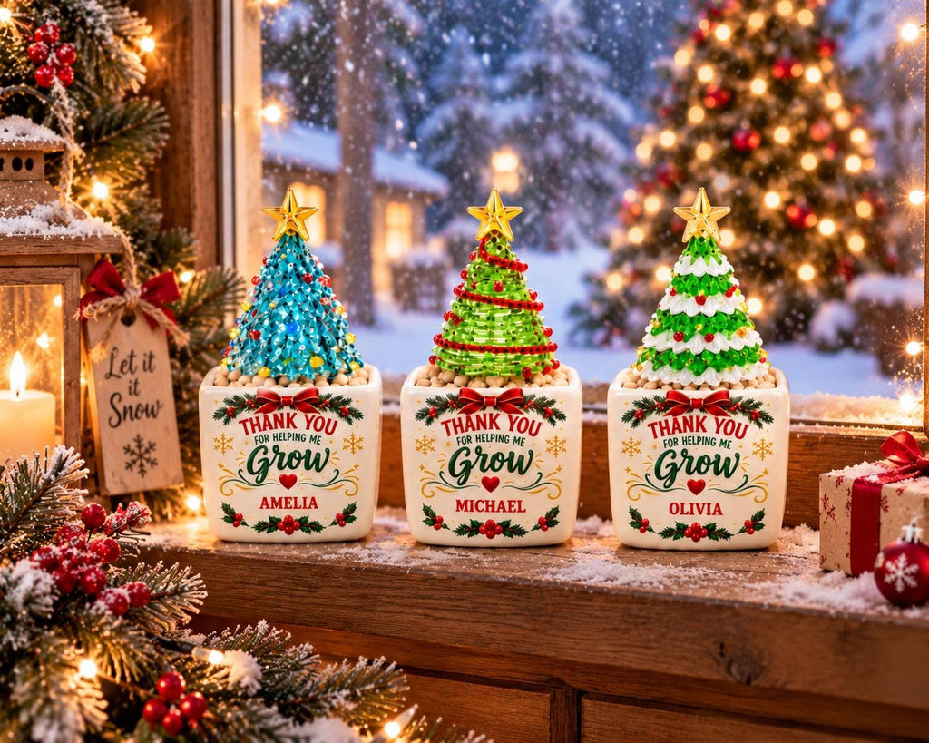 May include: Three square white ceramic planters, each topped with a decorative cone-shaped Christmas tree. The planters feature the text Thank You for helping me Grow, with the names Amelia, Michael, and Olivia printed in red below the text.
