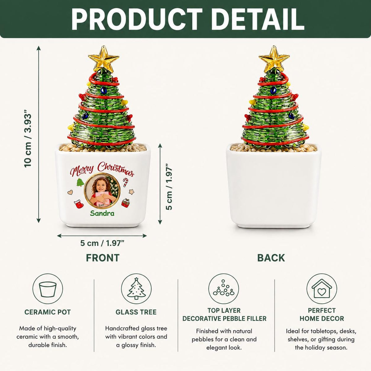 May include: A green wire-wrapped Christmas tree ornament with a gold star topper, set in a white ceramic pot filled with pebbles. The pot features the text Merry Christmas, a circular photo, and the name Sandra. It measures 3.93 inches by 1.97 inches.