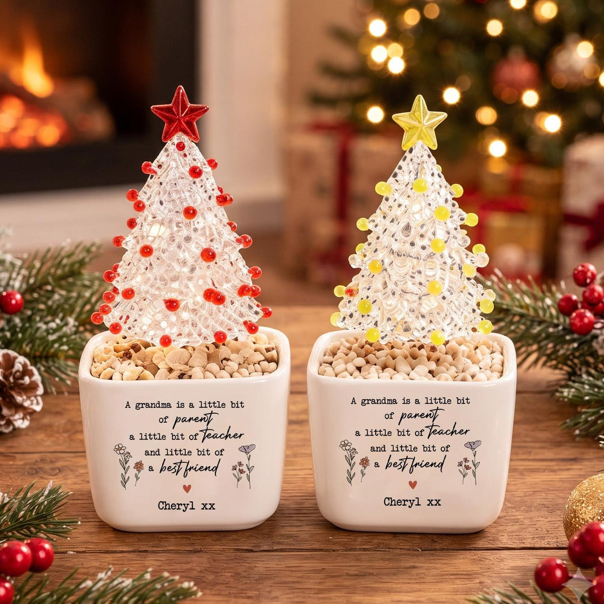 May include: Two white ceramic square planters containing clear textured Christmas tree ornaments with red and yellow beads, topped with matching stars. The planters feature the text: A grandma is a little bit of parent a little bit of teacher and little bit of a best friend, Cheryl xx.