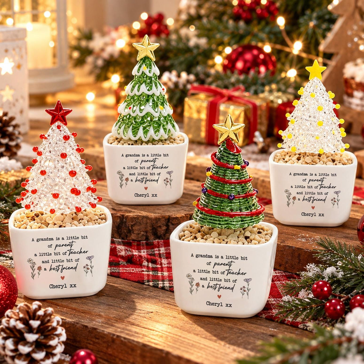 May include: Four small decorative Christmas trees in white square ceramic pots. Each pot features the printed text: A grandma is a little bit of parent a little bit of teacher and little bit of a best friend, followed by the name Cheryl xx.