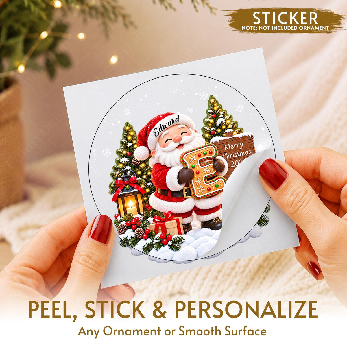May include: A circular sticker featuring a cartoon Santa Claus holding a gingerbread letter E, with the name Edward on his hat, a lantern, a Christmas tree, and a sign reading Merry Christmas 2024, set against a snowy background.