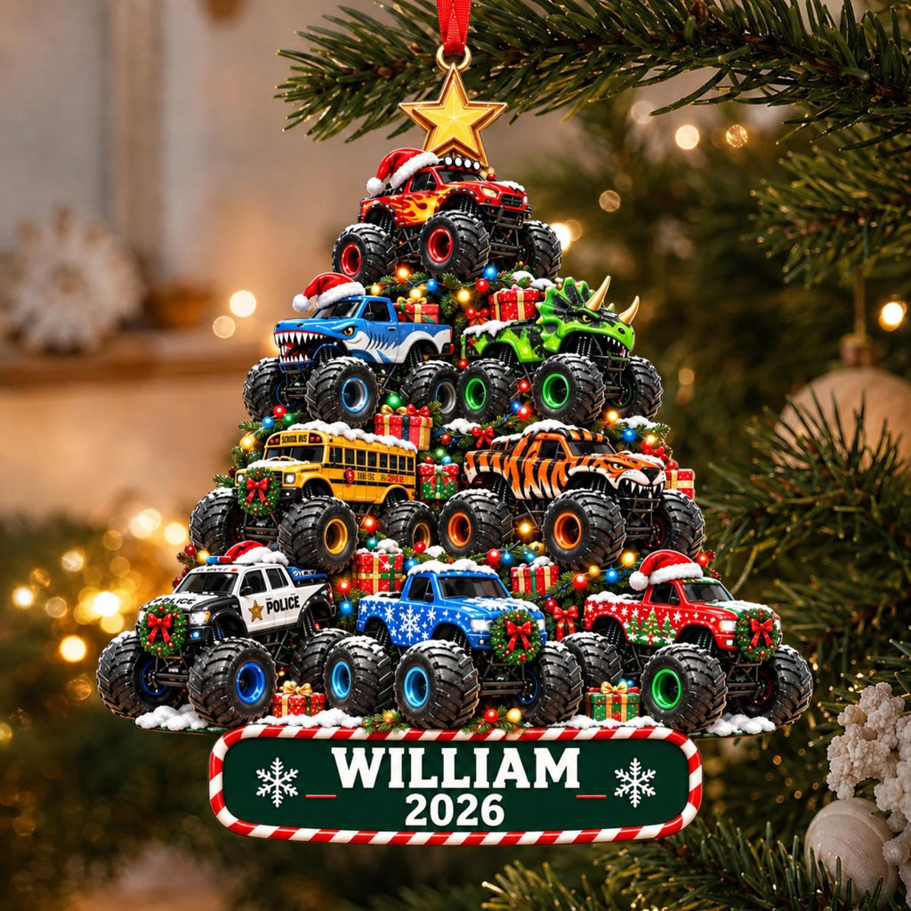May include: A Christmas tree-shaped ornament featuring stacked monster trucks, including a police vehicle, a school bus, and a dinosaur-themed truck. The ornament is topped with a gold star and includes a green nameplate reading WILLIAM 2026.
