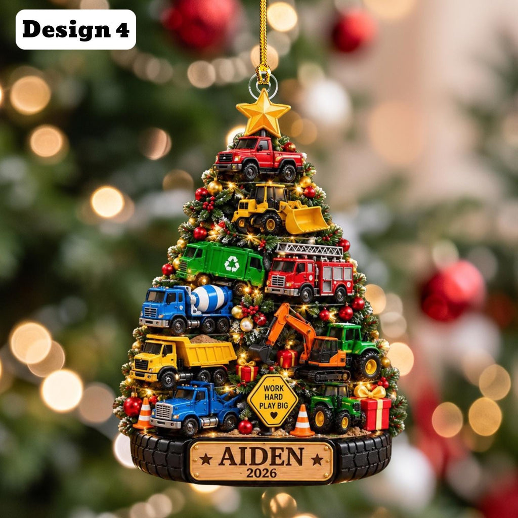 May include: A Christmas tree-shaped ornament featuring various construction vehicles, including a red truck, yellow bulldozer, green garbage truck, fire engine, blue cement mixer, yellow dump truck, and excavator. It includes a sign reading WORK HARD PLAY BIG and a base labeled AIDEN 2026.