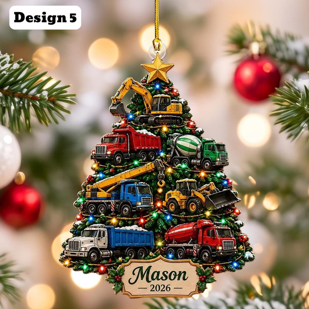 May include: A Christmas tree-shaped ornament featuring construction vehicles including an excavator, dump trucks, a cement mixer, and a crane. The ornament is decorated with colorful lights and a gold star at the top. A plaque at the bottom reads Mason 2026.
