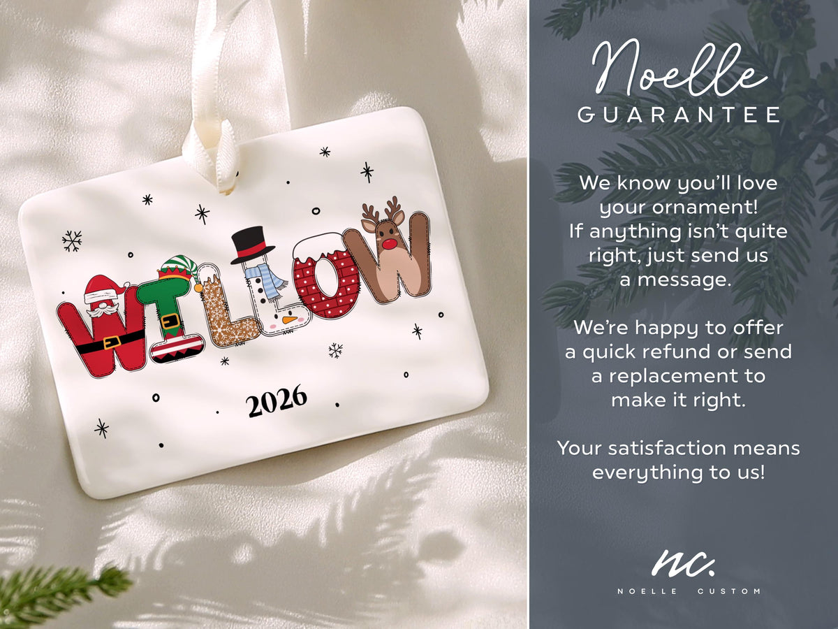 May include: A rectangular white ceramic Christmas ornament featuring the name WILLOW spelled out in festive holiday-themed letters, including Santa, elf, gingerbread, snowman, and reindeer motifs, with the year 2026 printed below in black.