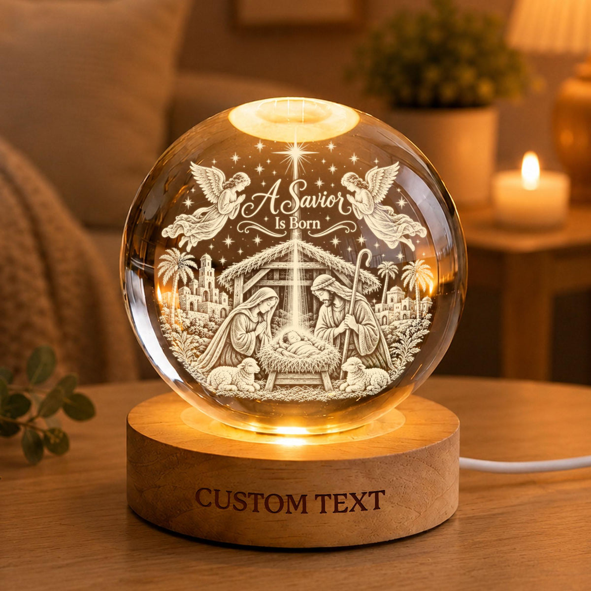 May include: A clear glass sphere lamp featuring a 3D laser-engraved nativity scene with the text A Savior Is Born, two angels, and a manger. The sphere rests on a round wooden base with the engraved text CUSTOM TEXT and an integrated light.