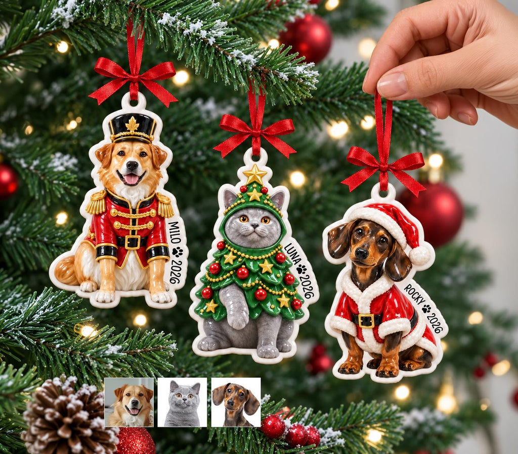 May include: Three flat ceramic ornaments hanging by red ribbons. One shows a golden retriever in a red nutcracker uniform labeled Milo 2026, one a gray cat in a Christmas tree costume labeled Luna 2026, and one a dachshund in a Santa suit labeled Rocky 2026.