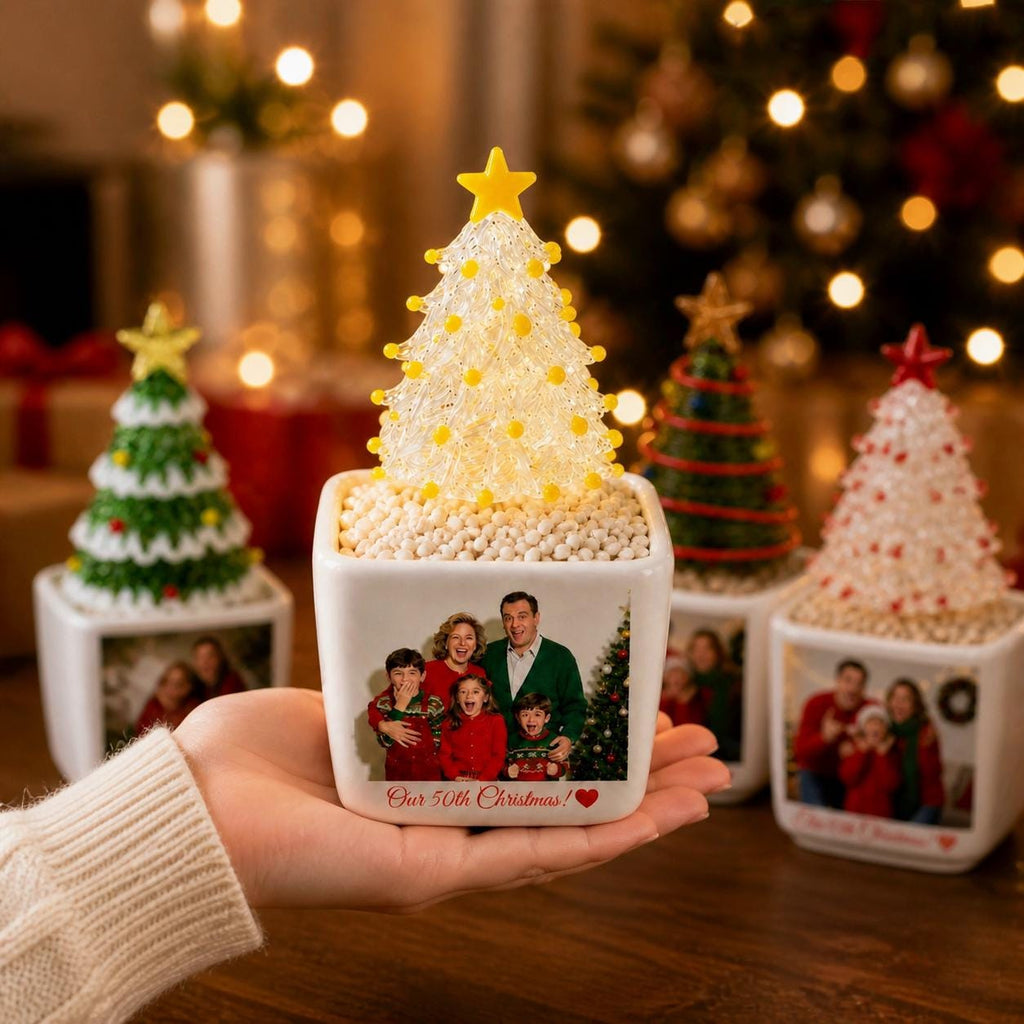 May include: A square white ceramic planter featuring a custom family photograph and the text "Our 50th Christmas!" with a red heart. The planter holds a textured, translucent white Christmas tree ornament topped with a yellow star.