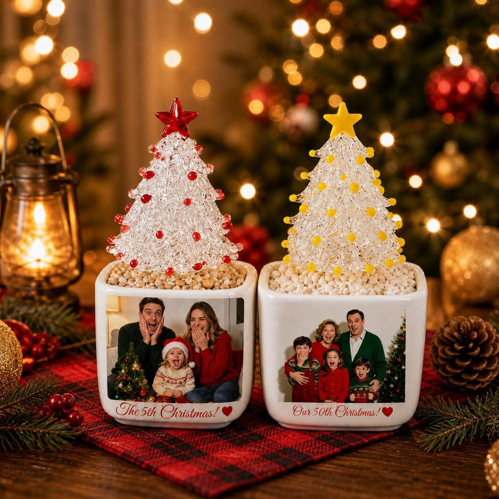 May include: Two square white ceramic planters featuring custom family photos and the text The 5th Christmas and Our 50th Christmas. Each planter holds a clear glass Christmas tree ornament, one topped with a red star and red beads, the other with a yellow star and yellow beads.
