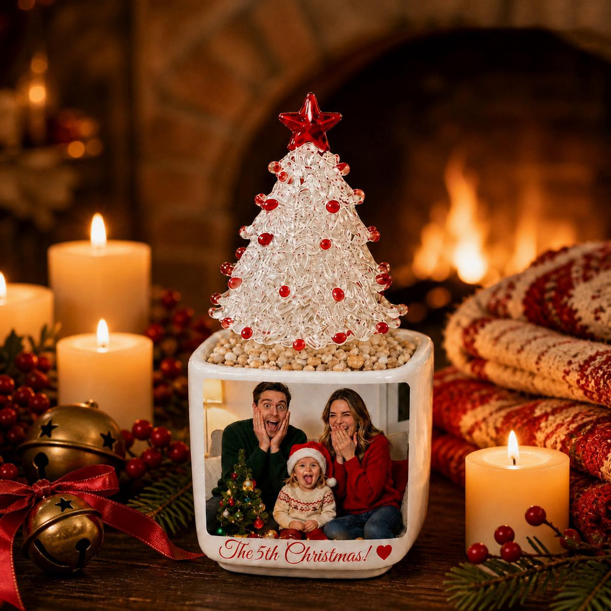May include: A square white ceramic planter featuring a photo of a family with a child, with the text The 5th Christmas! and a red heart. A clear glass Christmas tree with red accents and a red star topper sits in the planter filled with small stones.