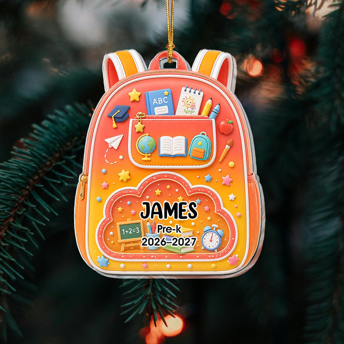 May include: A backpack-shaped ornament featuring a gradient orange and yellow design. It displays school-themed icons like a globe, books, and pencils. The text reads JAMES, Pre-k, and 2026-2027, with a small chalkboard showing 1+2=3.