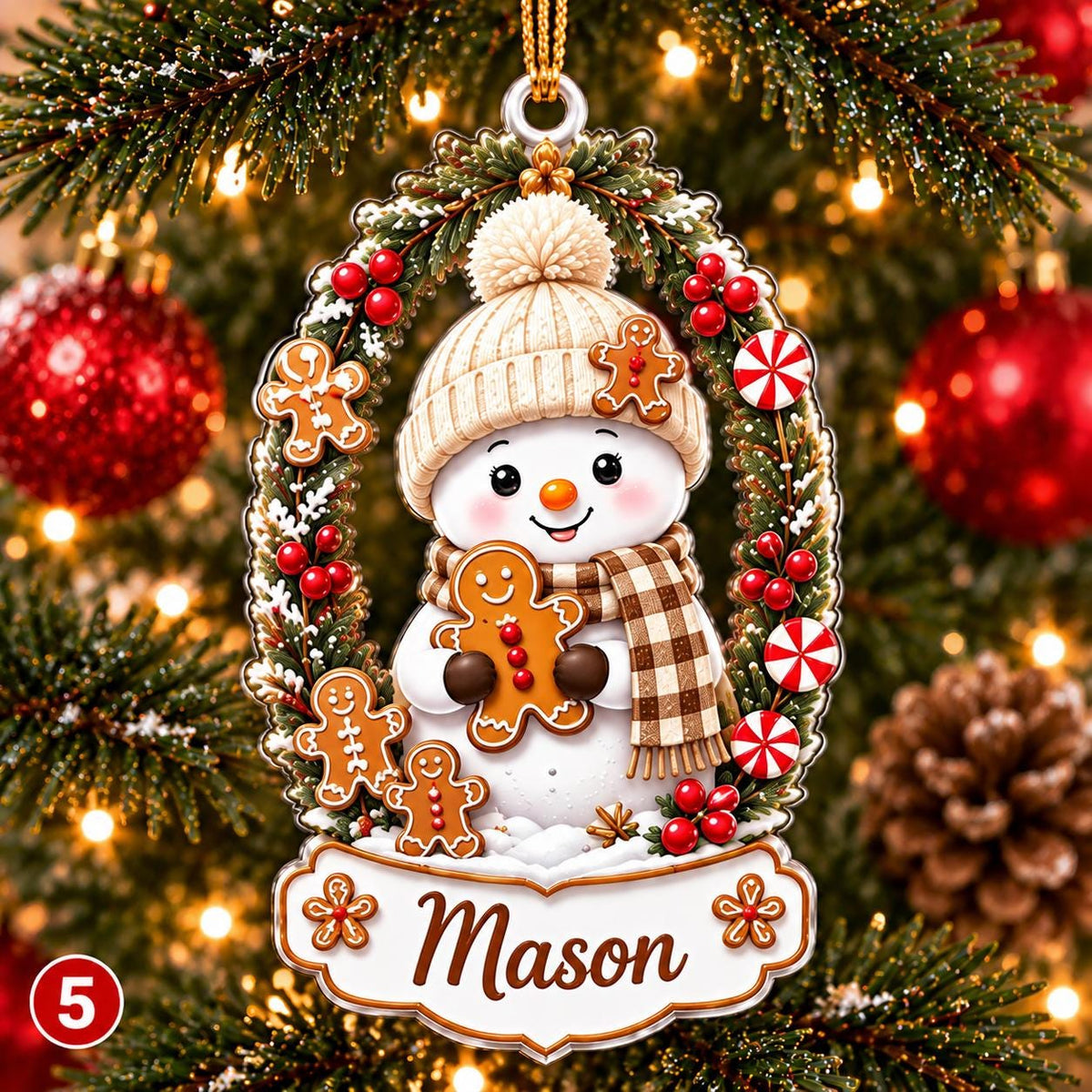 May include: An oval Christmas ornament featuring a snowman wearing a beige knit hat and a brown plaid scarf. The snowman holds a gingerbread cookie, surrounded by a wreath of pine branches, red berries, and peppermint candies. The name Mason is printed.