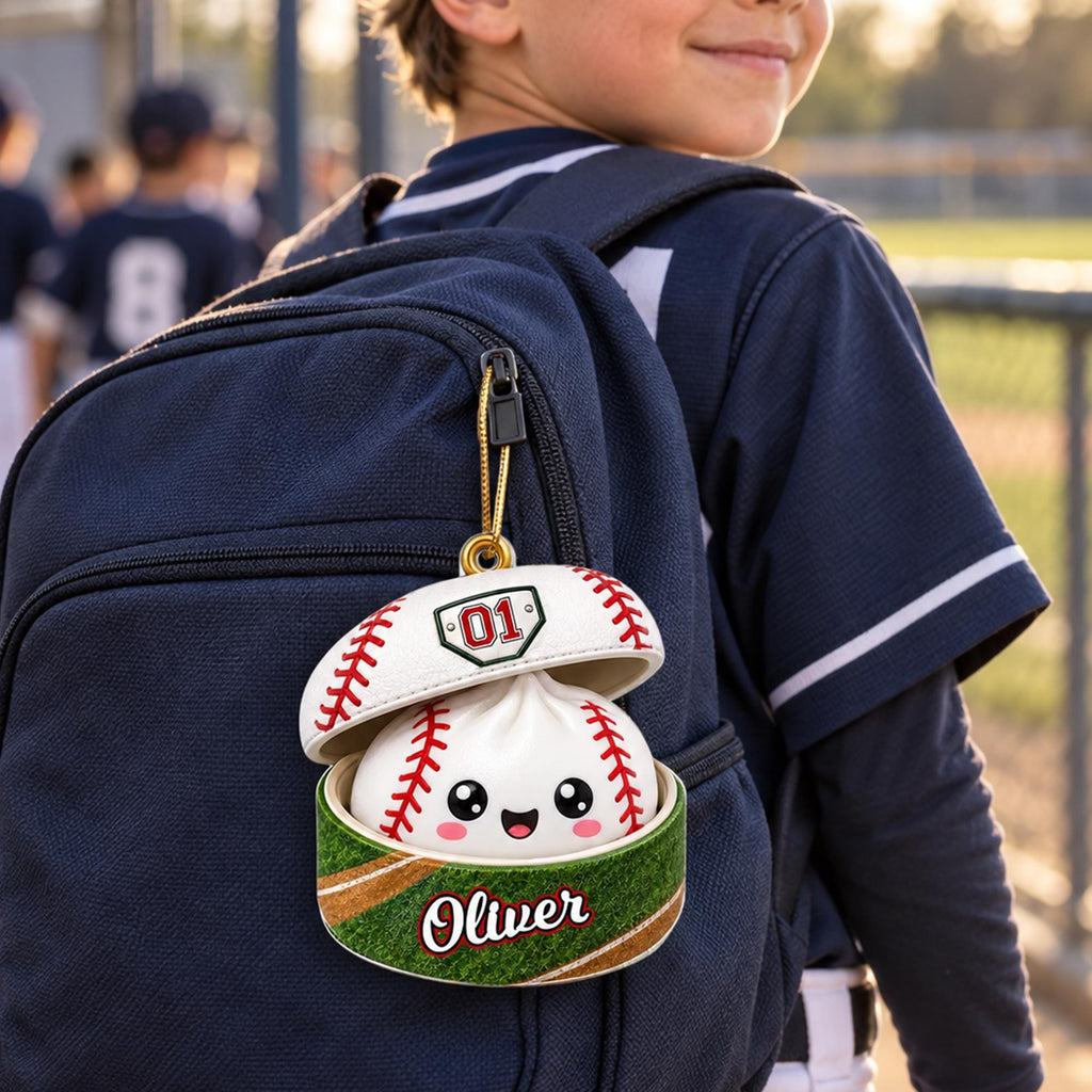 A child wearing a baseball uniform and carrying a backpack with a personalized baseball cap attached to it.