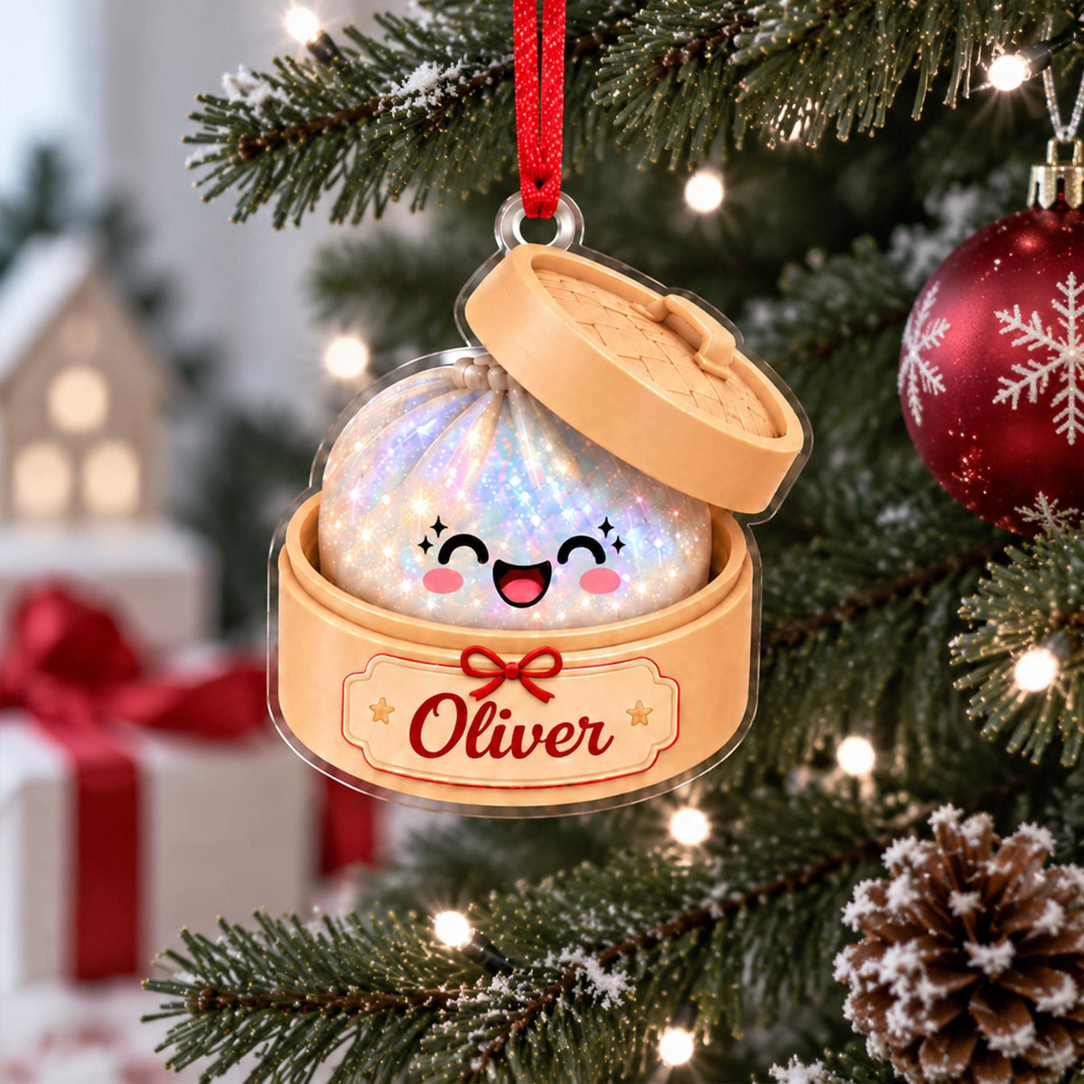 May include: A clear acrylic Christmas ornament shaped like a bamboo steamer basket containing a sparkling, iridescent dumpling character with a smiling face. The base features a label with the name Oliver in red script and a red ribbon hanger.