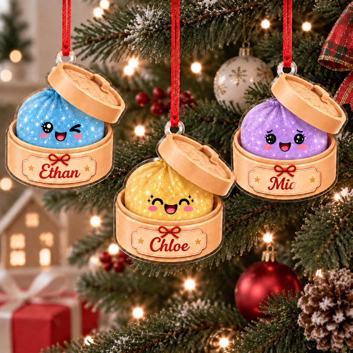 May include: Three acrylic Christmas ornaments shaped like bamboo steamer baskets containing sparkling blue, yellow, and purple dumplings with smiling faces. Each ornament features a red hanging ribbon and a label with the names Ethan, Chloe, or Mia.