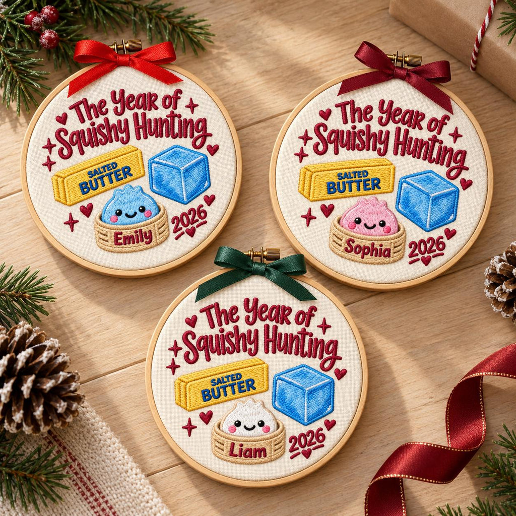 May include: Three circular embroidery hoops featuring white fabric with the embroidered text The Year of Squishy Hunting, a yellow stick of salted butter, a blue cube, and a cute dumpling in a basket. Each hoop includes a name and the year 2026.