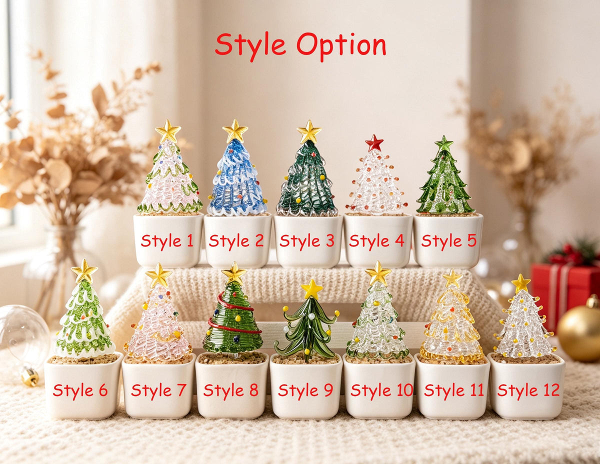 May include: Twelve miniature glass Christmas trees in white square pots, labeled Style 1 through Style 12. Each tree features a unique design with various colors, textures, and a star topper. The trees are arranged in two rows on a textured surface.