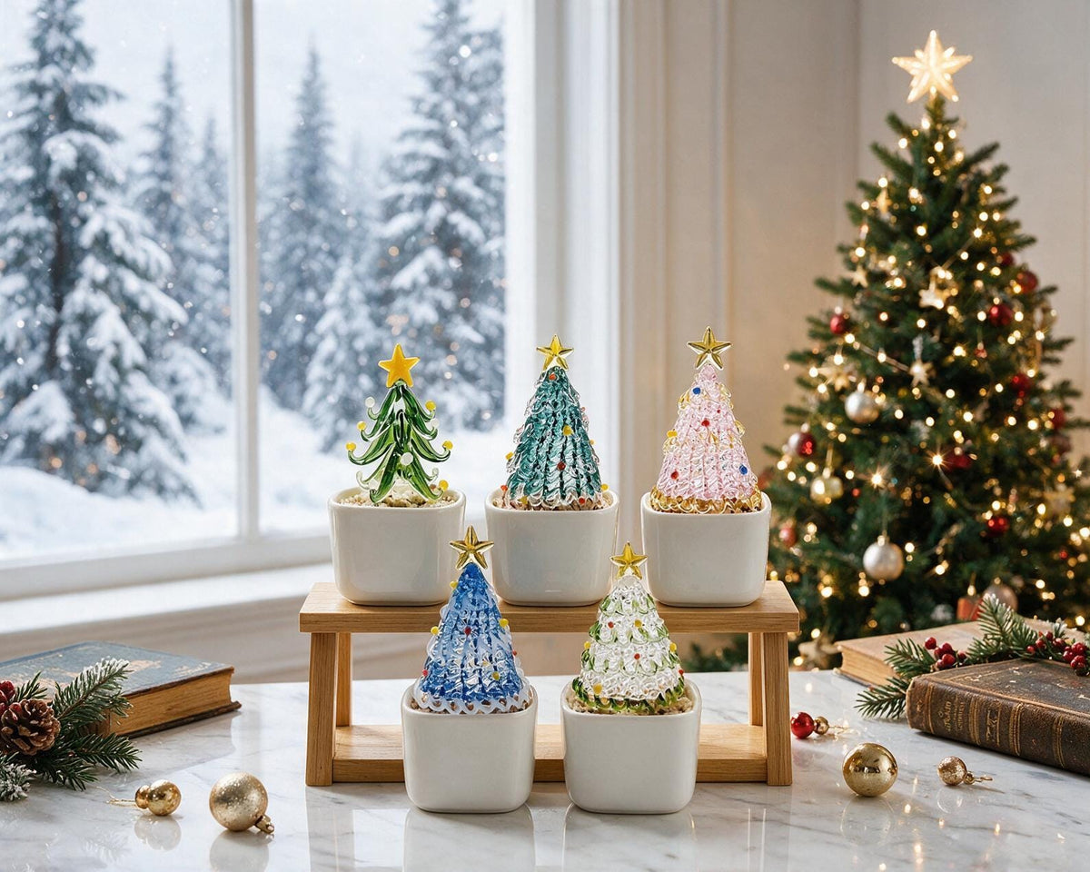 May include: Five miniature glass Christmas trees in white square ceramic pots, arranged on a two-tiered wooden stand. The trees feature various colors including green, blue, pink, and clear glass, each topped with a small gold-colored star.